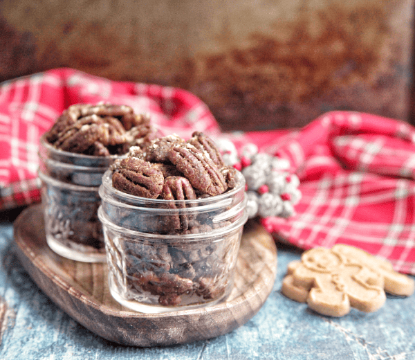 These spiced candied pecans are a perfect way to snack through the holidays. These pecans can be packaged up in mason jars to make a perfect gift for friends and family.  #paleo #glutenfree #dairyfree