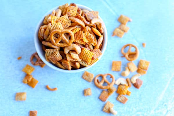 This buffalo party mix is gluten free and made with corn cereal, rice cereal, cashews and gluten free pretzels. Perfect for game day parties.
