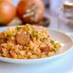 This cajun cauliflower rice is a paleo, whole30, and keto take on dirty rice. It uses riced cauliflower, andouille sausage, pepper, onion and creole and cajun seasonings to make an easy one pot skillet meal. #whole30 #paleo #keto