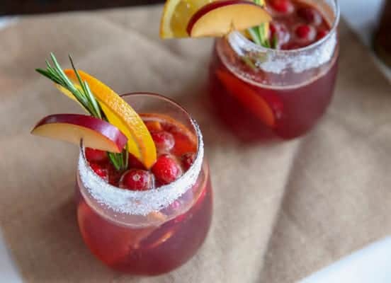 This easy Christmas punch is made with fresh ingredients like ginger ale, cranberry juice, plums and orange with a touch of cinnamon. Makes a great cocktail or mocktail for december holiday parties.
