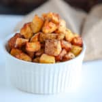 This recipe for crispy air fryer potatoes is simple and finished within 20 minutes. Using oil, seasonings and golden potatoes, the air fryer makes crispy potatoes that are a perfect side dish or breakfast side. Compliant with paleo and whole30 diets. 