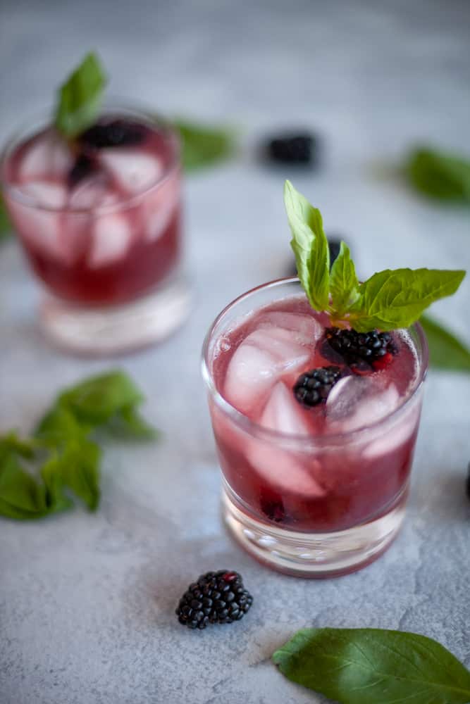 This blackberry basil mocktail may be lacking alcohol but it does not lack flavor!  The combination of blackberry, basil and lime sparkling water make a tart and sweet drink great for any party or to have at home without the hangover. #mocktail