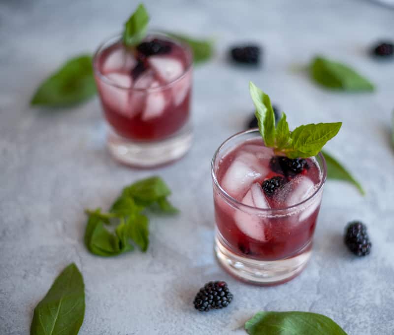 This blackberry basil mocktail may be lacking alcohol but it does not lack flavor!  The combination of blackberry, basil and lime sparkling water make a tart and sweet drink great for any party or to have at home without the hangover. #cocktail #mocktail