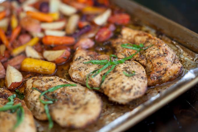 balsamic chicken breast topped with basil next to vegetables