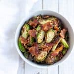 air fryer brussels sprouts and bacon in a white bowl