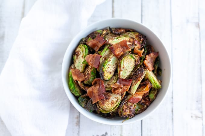 air fryer brussels sprouts and bacon in a white bowl