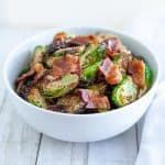 air fryer brussels sprouts with bacon in a white bowl