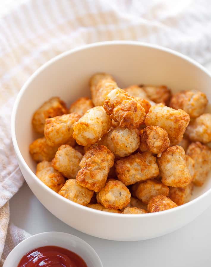 tater tots in a bowl with ketchup