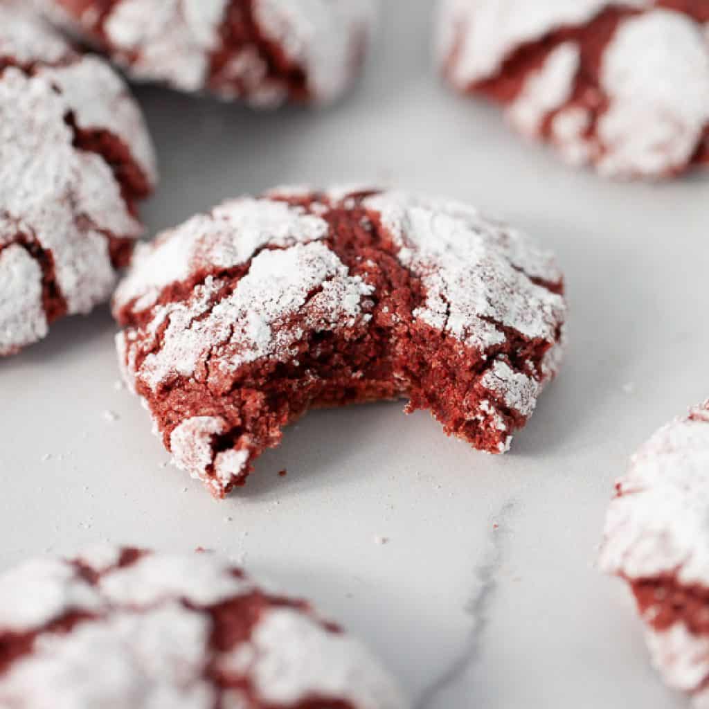 Gluten Free Red Velvet Crinkle Cookies with one missing a bite
