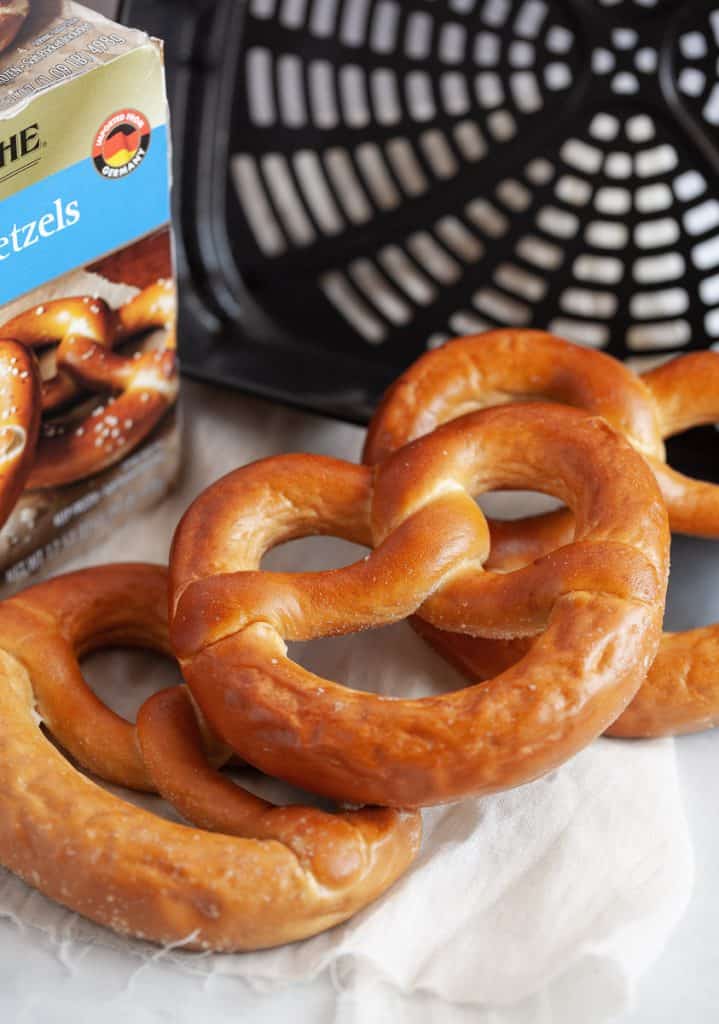 frozen soft pretzels next to air fryer basket