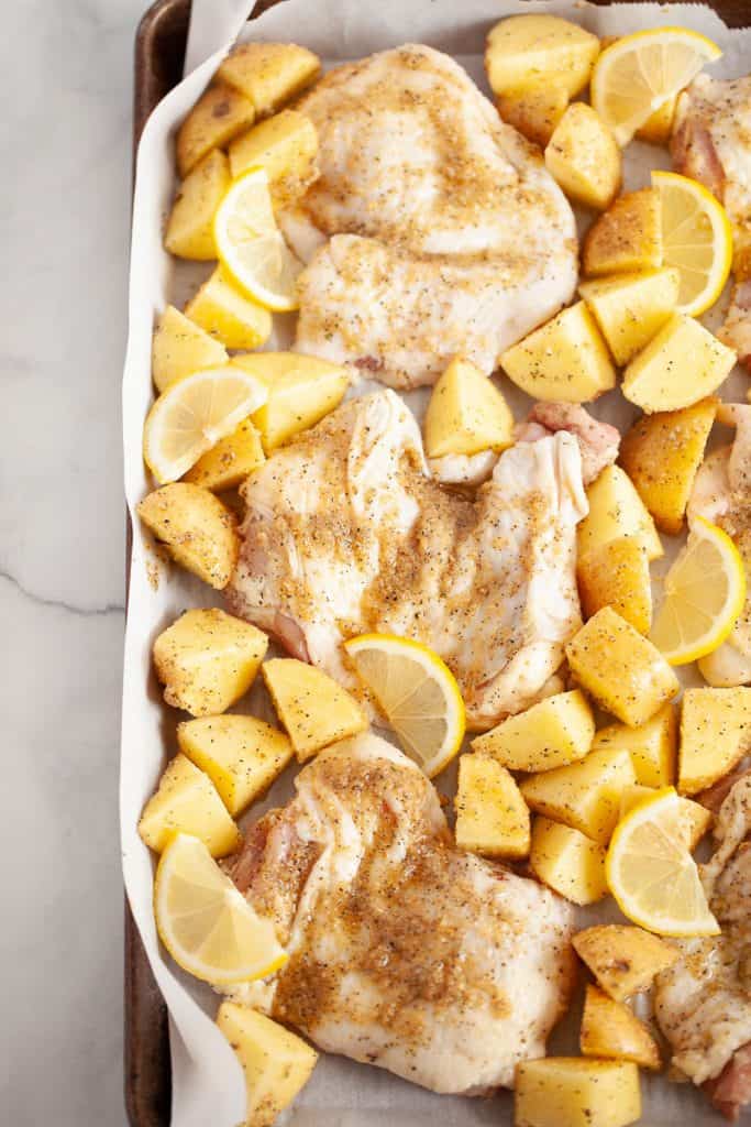 raw chicken thighs with lemon and potatoes
