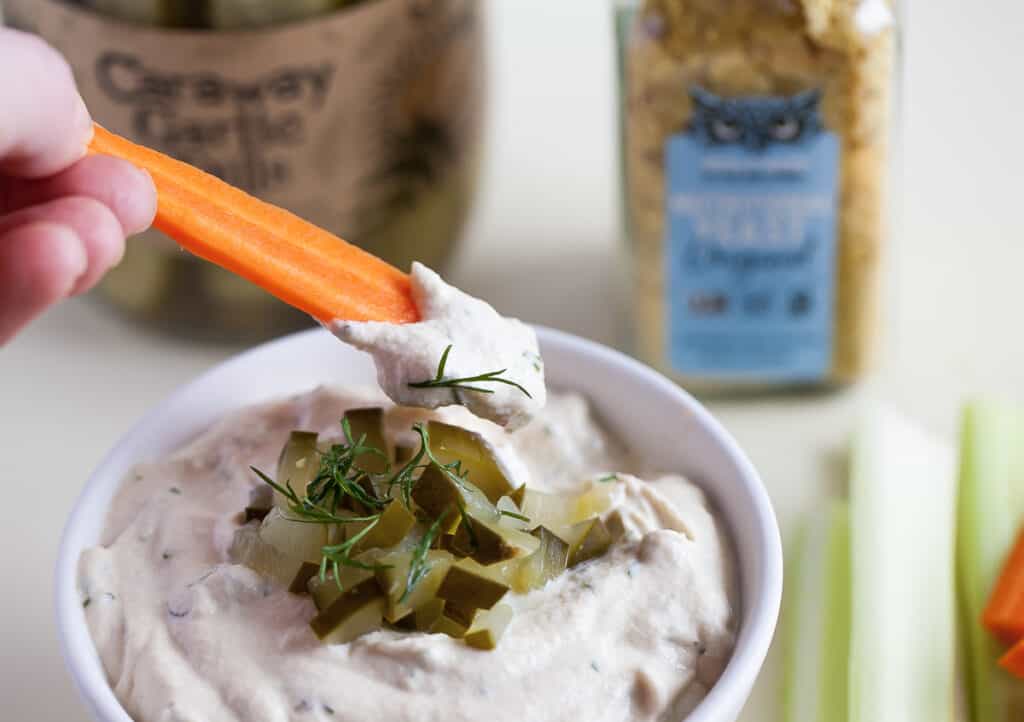 dill pickle dip with a carrot stick