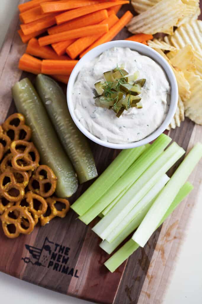 creamy dill pickle dip with vegetables and chips