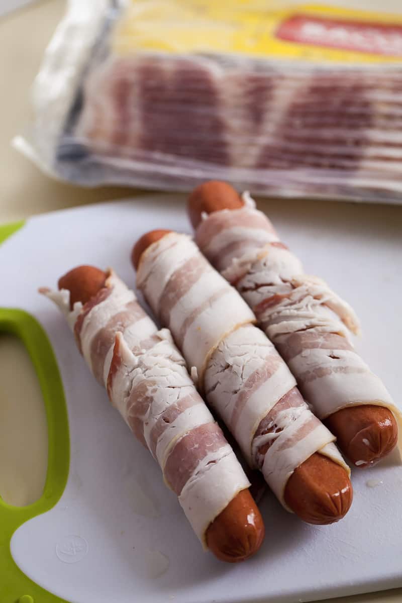 raw bacon wrapped around hot dogs