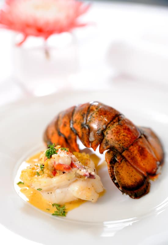 cooked lobster tail on a plate with the shell