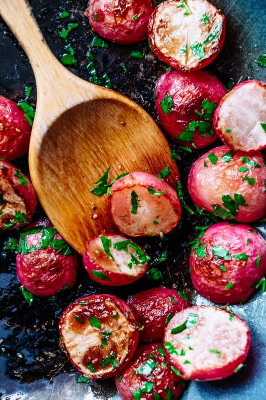 roasted radishes with a wooden spoon