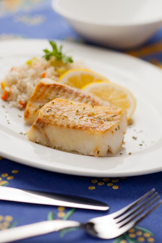 cod on a plate with a fork