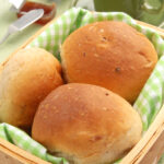 dinner rolls in a basket with coffee