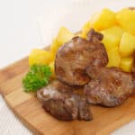 chicken liver on a cutting board with potatoes