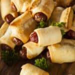 pigs in a blanket on a piece of wood