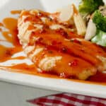 orange roughy on a plate with vegetables