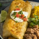 chimichanga on a plate with sour cream